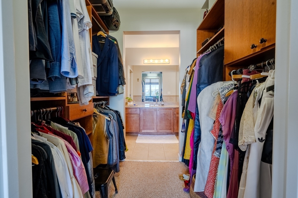 160 Fremont Street, Unit 405 Worcester, MA 01603 - Photo 18 of 34 a view of walk in closet with clothes and shoes