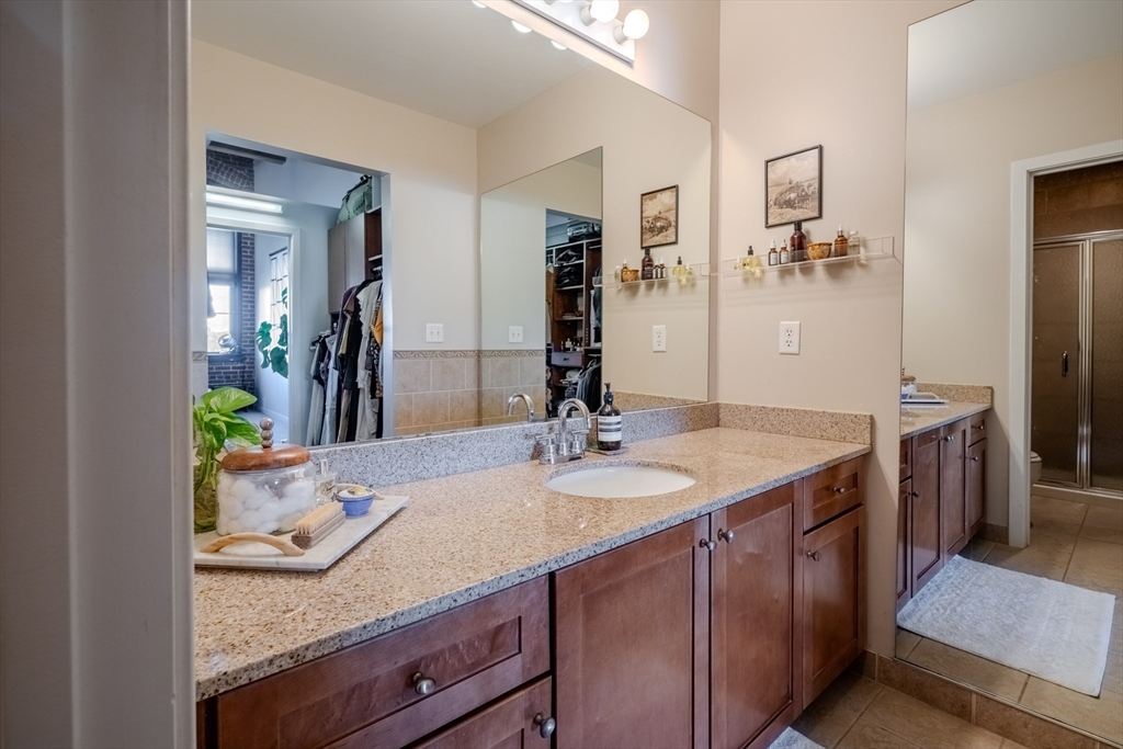 160 Fremont Street, Unit 405 Worcester, MA 01603 - Photo 19 of 34 a bathroom with a granite countertop sink and a mirror