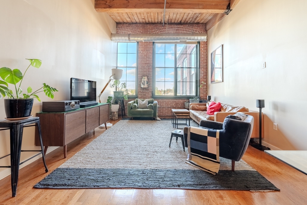 160 Fremont Street, Unit 405 Worcester, MA 01603 - Photo 2 of 34 a living room with furniture rug and a window