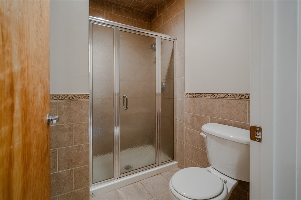160 Fremont Street, Unit 405 Worcester, MA 01603 - Photo 21 of 34 a bathroom with a toilet and a shower