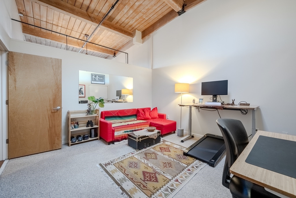 160 Fremont Street, Unit 405 Worcester, MA 01603 - Photo 23 of 34 a room with furniture a flat screen tv and a window