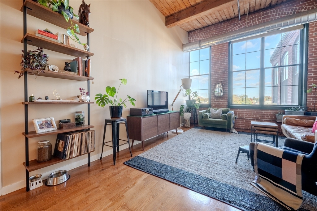 160 Fremont Street, Unit 405 Worcester, MA 01603 - Photo 3 of 34 a living room with furniture window and wooden floor