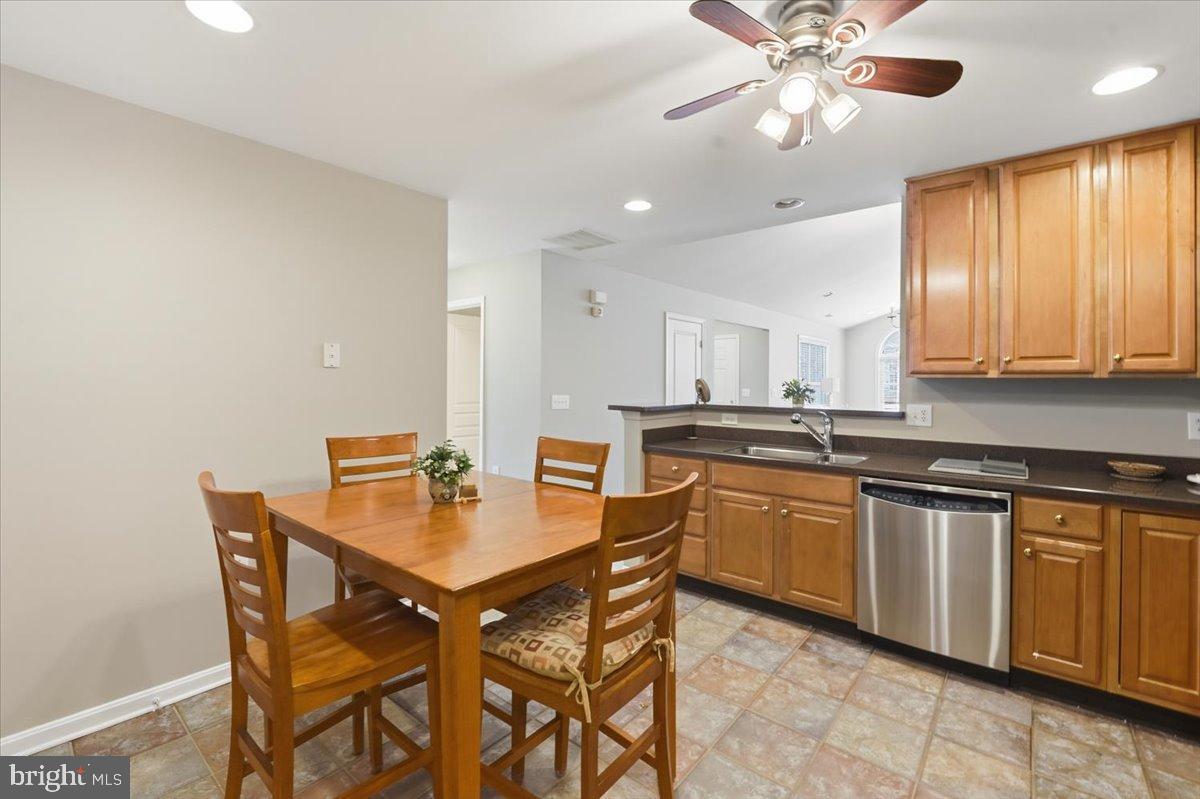 192 Federal Point Boulevard Lawrenceville, NJ 08648 - Photo 13 of 34 a kitchen with a dining table chairs and white cabinets