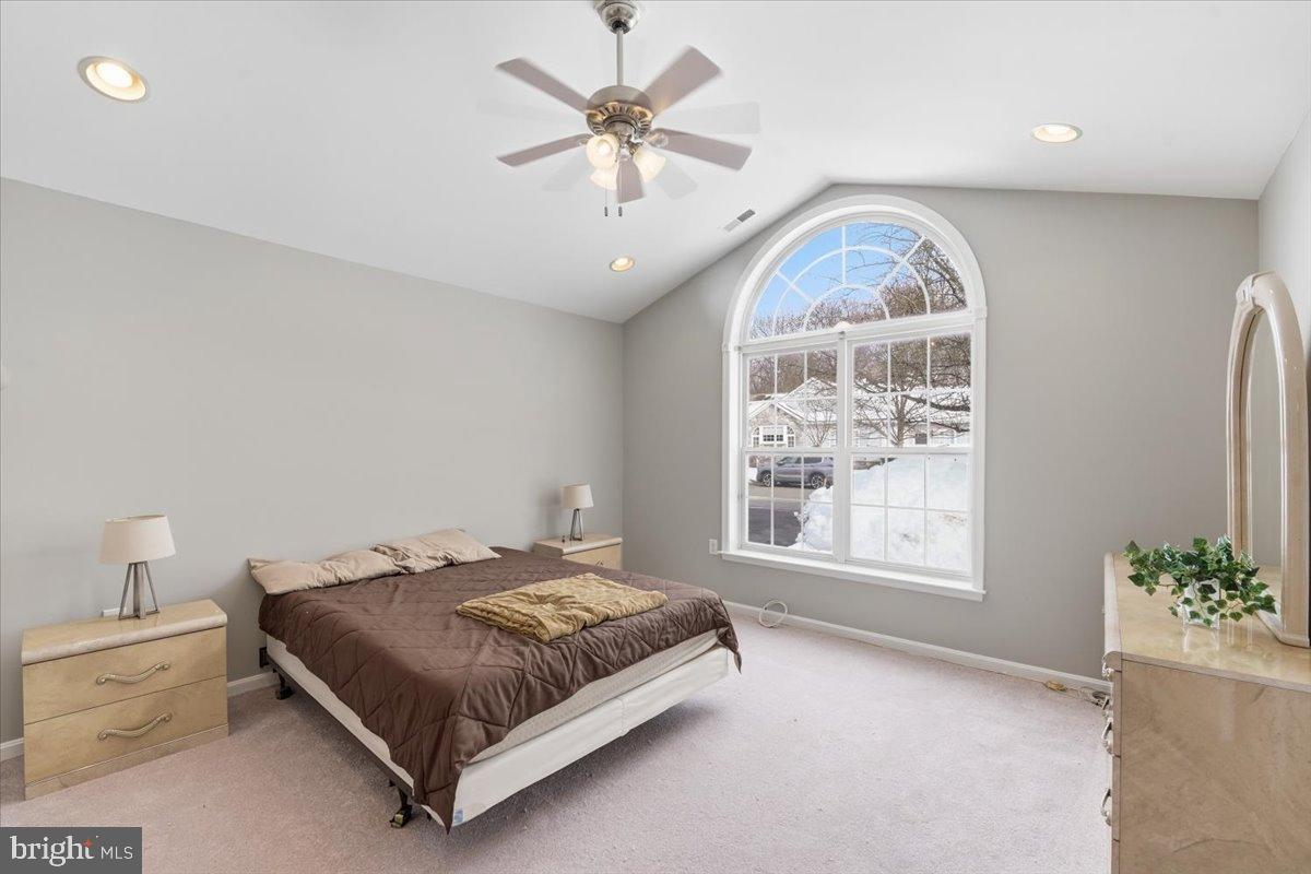 192 Federal Point Boulevard Lawrenceville, NJ 08648 - Photo 16 of 34 a bedroom with a bed and a chandelier