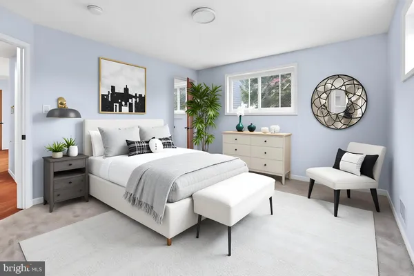 a bedroom with a bed and a large window