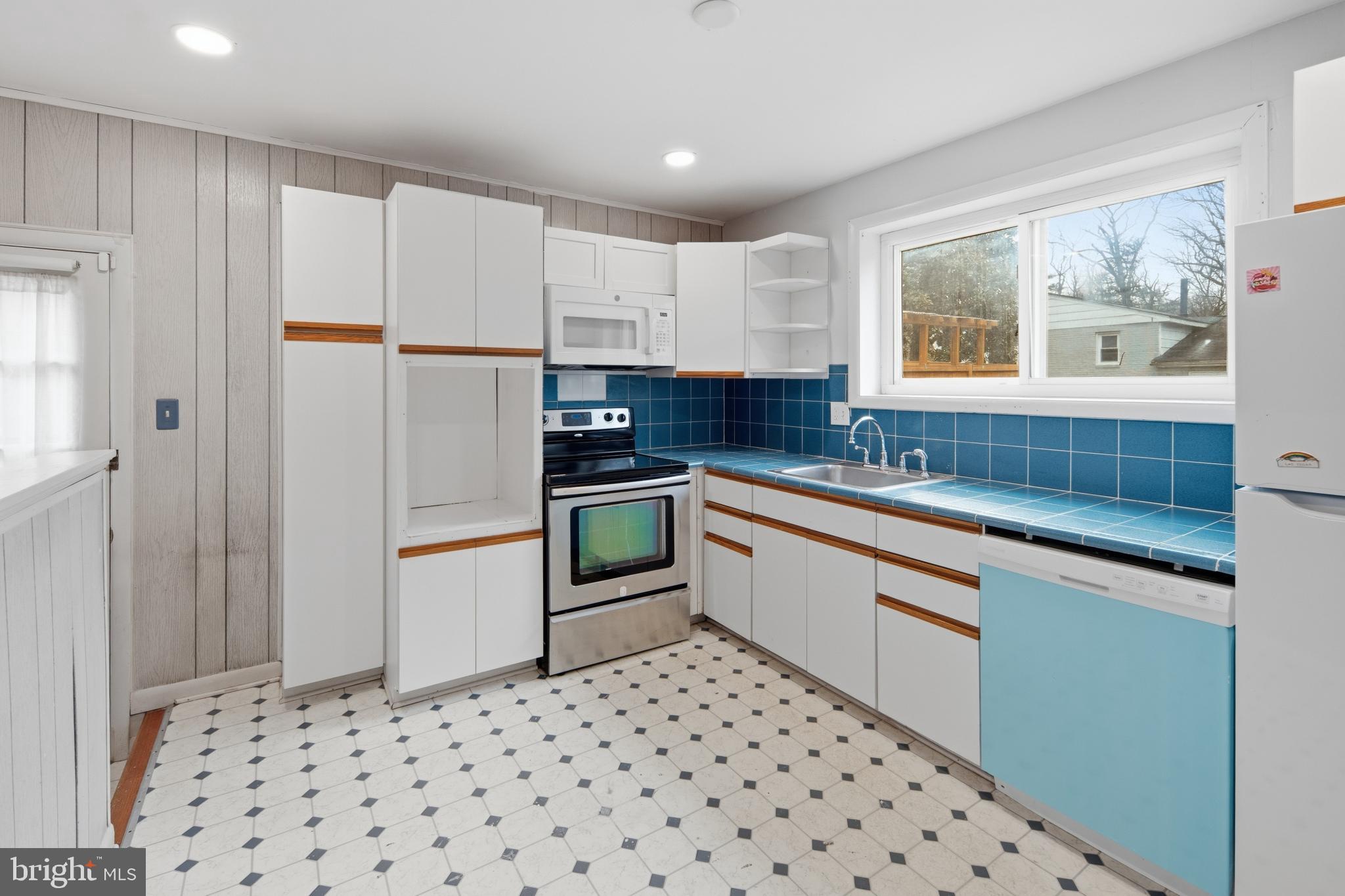 3505 N Street Southeast Washington, DC 20019 - Photo 13 of 29 a kitchen with a refrigerator and white cabinets
