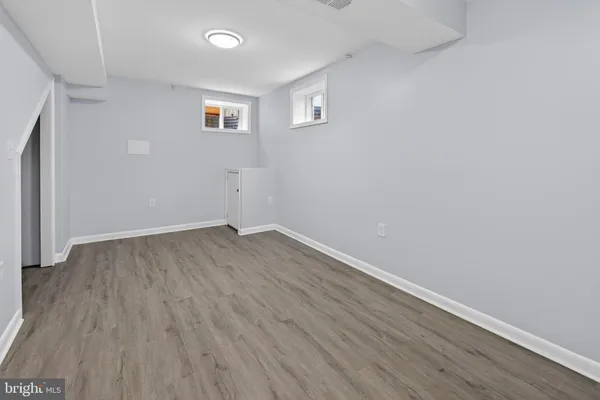 a view of a room with wooden floor and a window