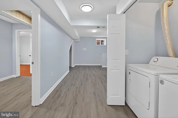 a view of hallway with wooden floor