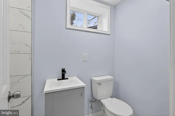 a white toilet sitting next to a bathroom sink