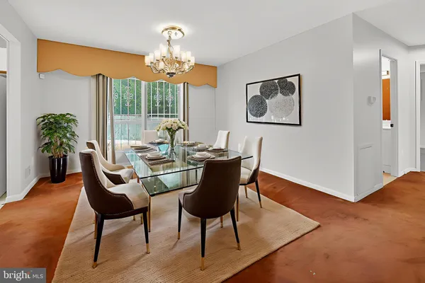 a dining room with furniture a chandelier and wooden floor