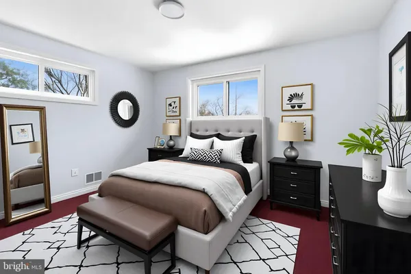 a bedroom with a bed and a potted plant