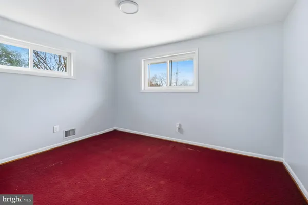 an empty room with a ceiling fan