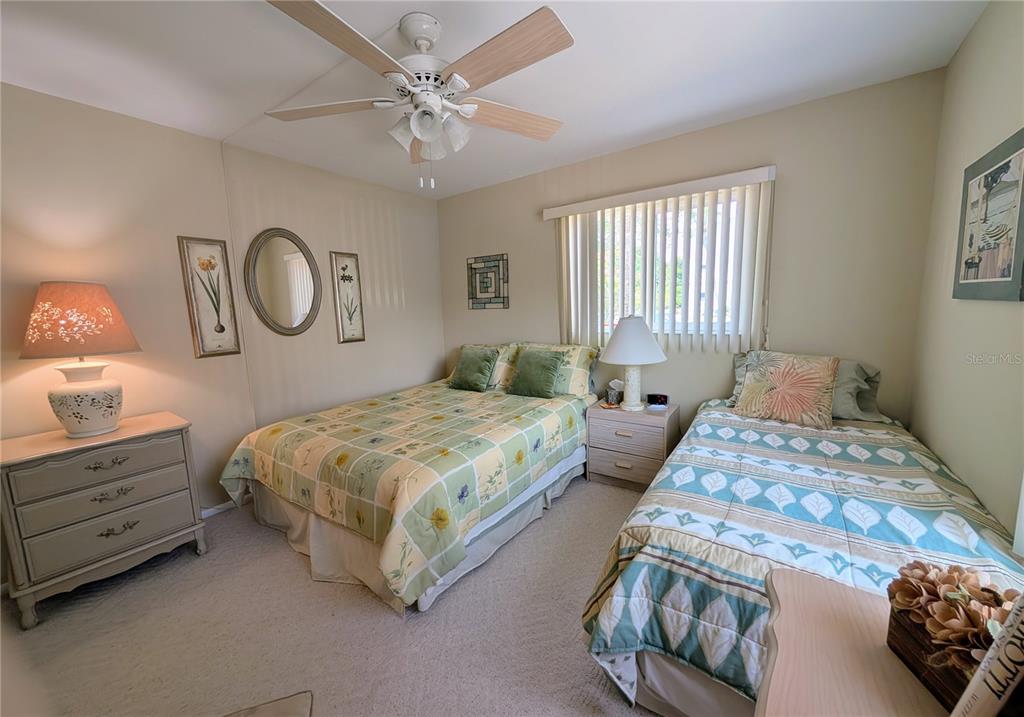5934 Welcome Road, Unit H7 Bradenton, FL 34207 - Photo 11 of 23 a bedroom with a bed and a chandelier