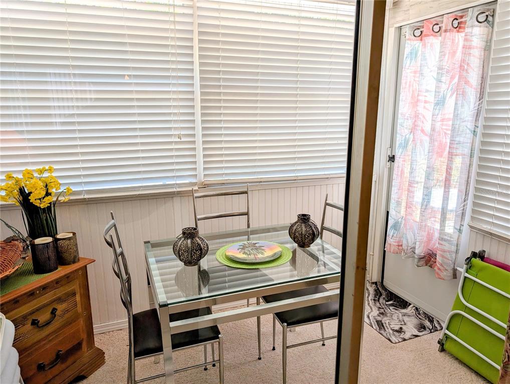 5934 Welcome Road, Unit H7 Bradenton, FL 34207 - Photo 17 of 23 a dining room with furniture and a window