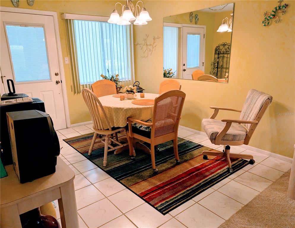 5934 Welcome Road, Unit H7 Bradenton, FL 34207 - Photo 2 of 23 a dining room with furniture and wooden floor