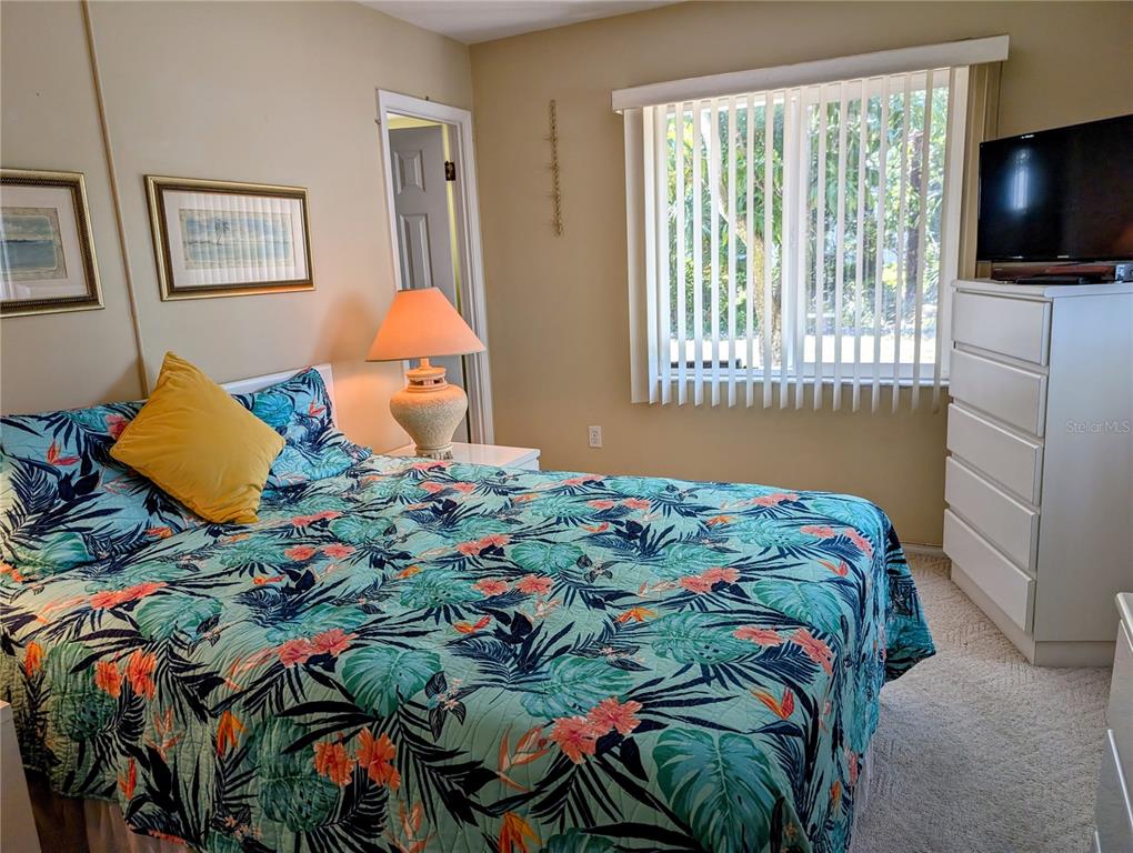 5934 Welcome Road, Unit H7 Bradenton, FL 34207 - Photo 9 of 23 a bedroom with a bed and flat screen tv