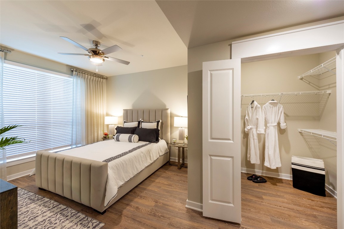1724 Partnership Way, Unit 1362 Katy, TX 77449 - Photo 25 of 31 a bedroom with a bed and a chandelier