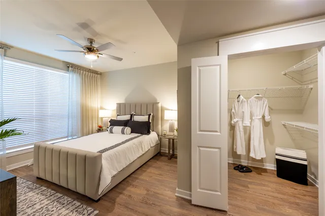 a bedroom with a bed and a chandelier