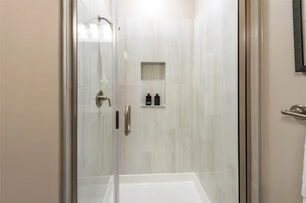 a bathroom with a granite countertop sink toilet and mirror