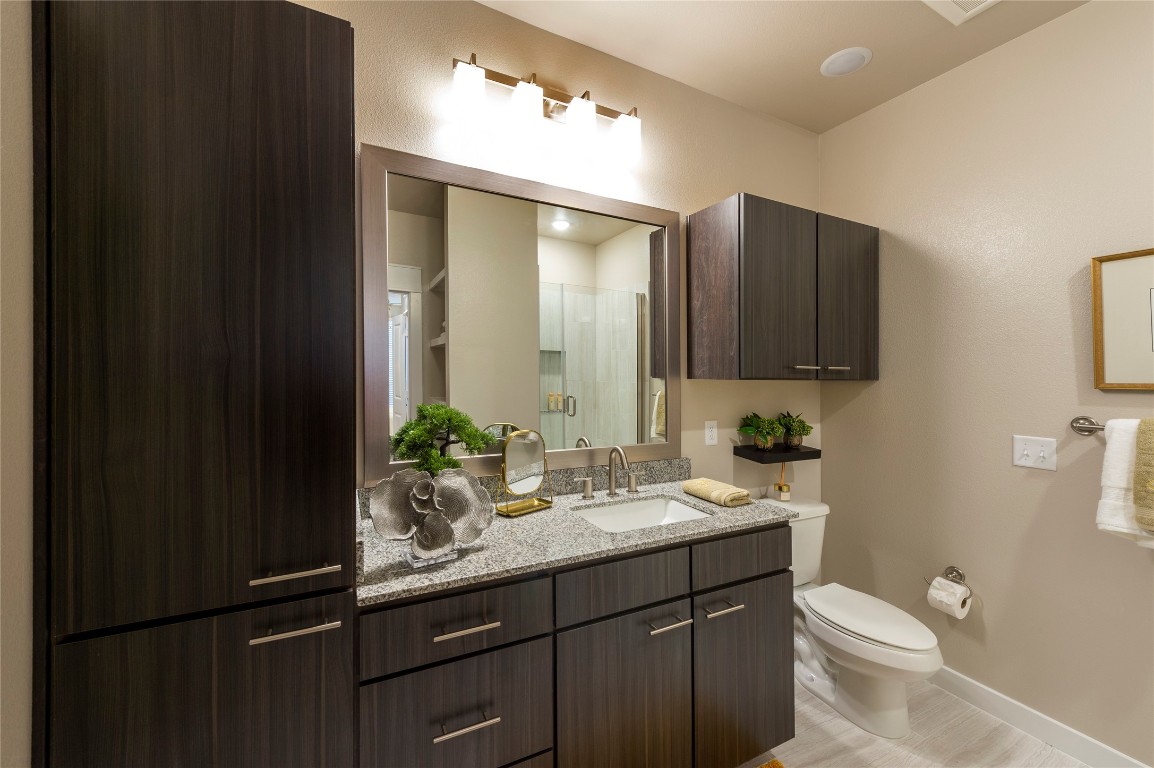 1724 Partnership Way, Unit 1362 Katy, TX 77449 - Photo 28 of 31 a bathroom with a granite countertop sink toilet and mirror
