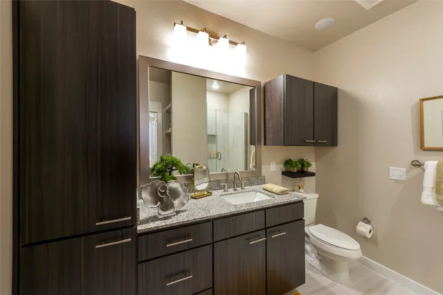 a bathroom with a glass shower door
