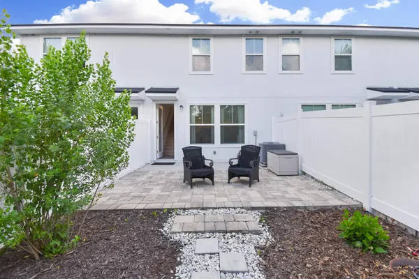 a backyard of a house with yard and outdoor seating