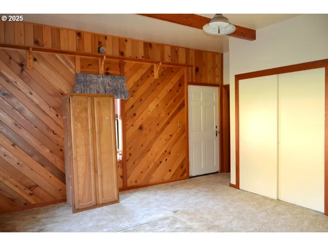 a view of a room with wooden walls
