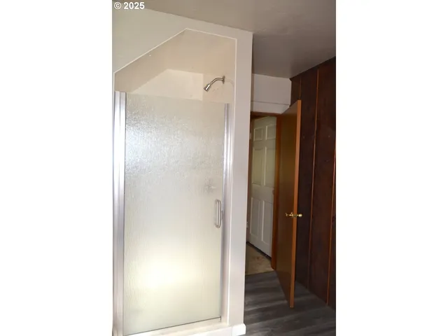a picture of a bathroom with a shower and a mirror