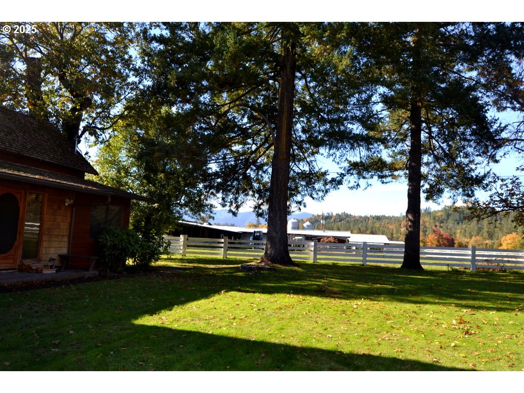6181 Lower River Road Grants Pass, OR 97526 - Photo 2 of 37 a view of swimming pool with table and chairs under an umbrella