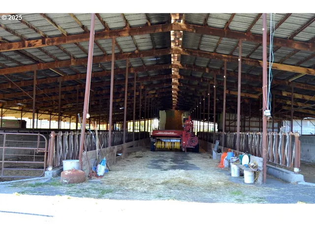 a view of a house with a patio and a yard