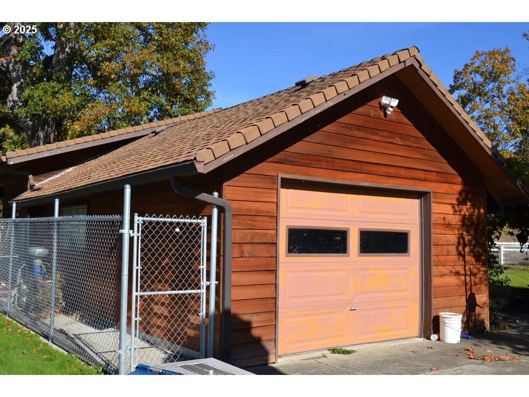 6181 Lower River Road Grants Pass, OR 97526 - Photo 24 of 37 a front view of a house with a garage