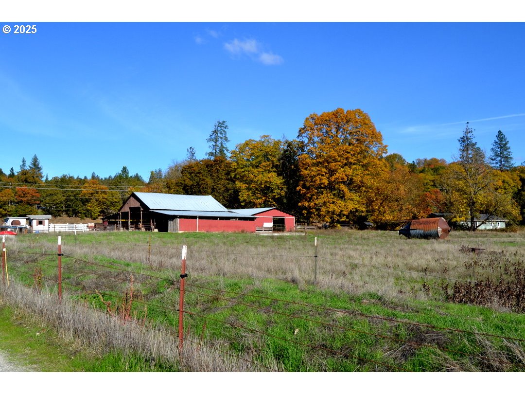 6181 Lower River Road Grants Pass, OR 97526 - Photo 36 of 37 a backyard of a house with lots of green space