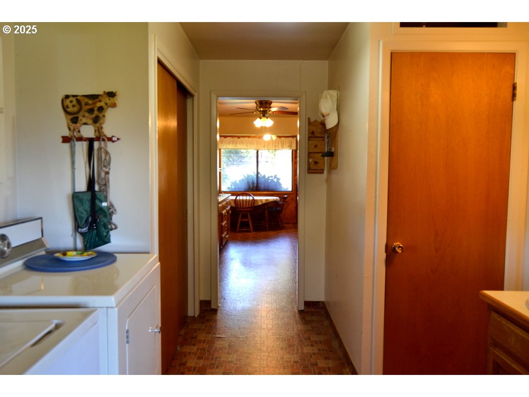 6181 Lower River Road Grants Pass, OR 97526 - Photo 8 of 37 a view of a hallway with wooden floor and a living room