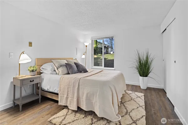 a kitchen with stainless steel appliances a sink cabinets and wooden floor