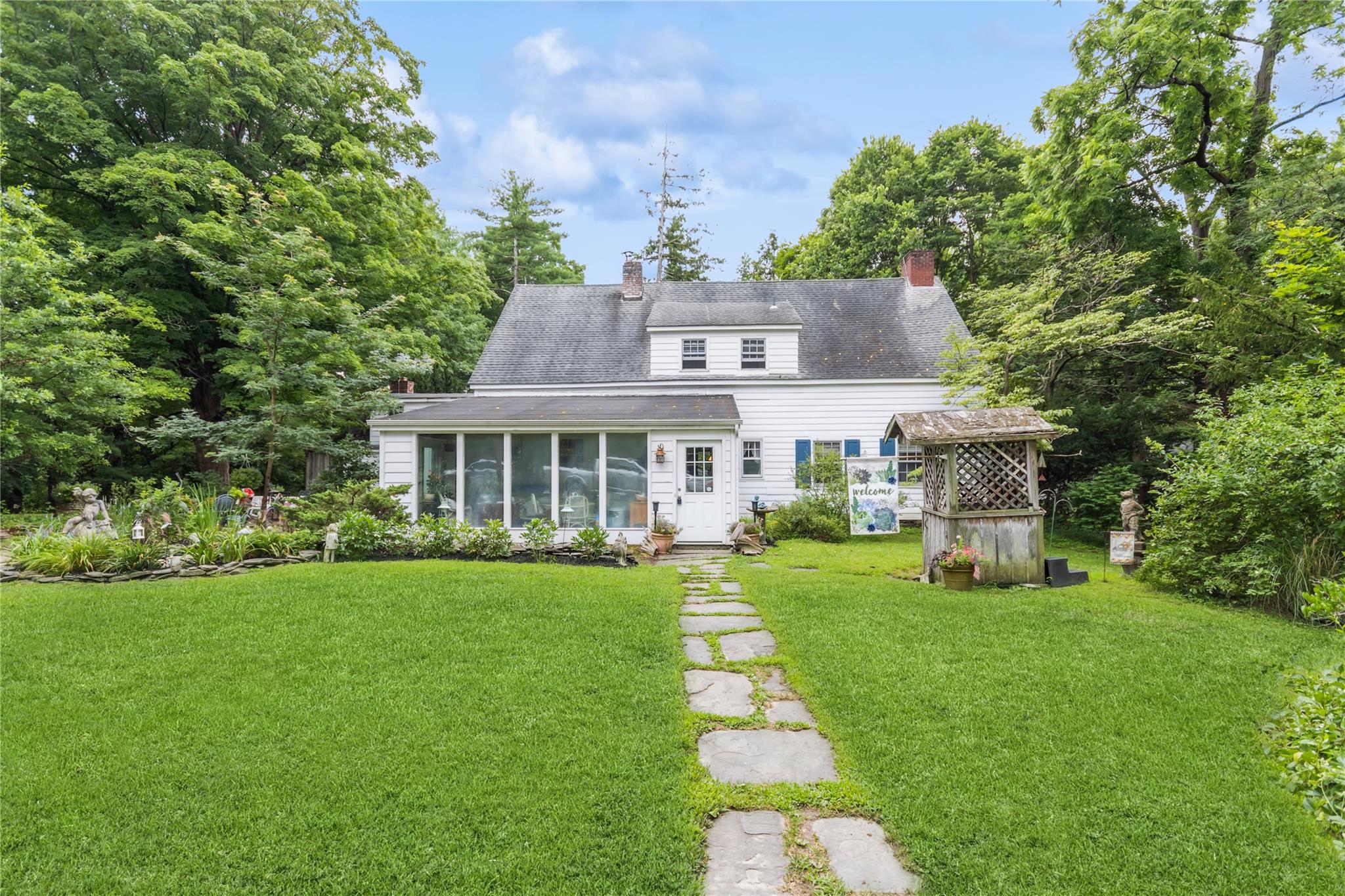 a front view of a house with a yard table and chairs