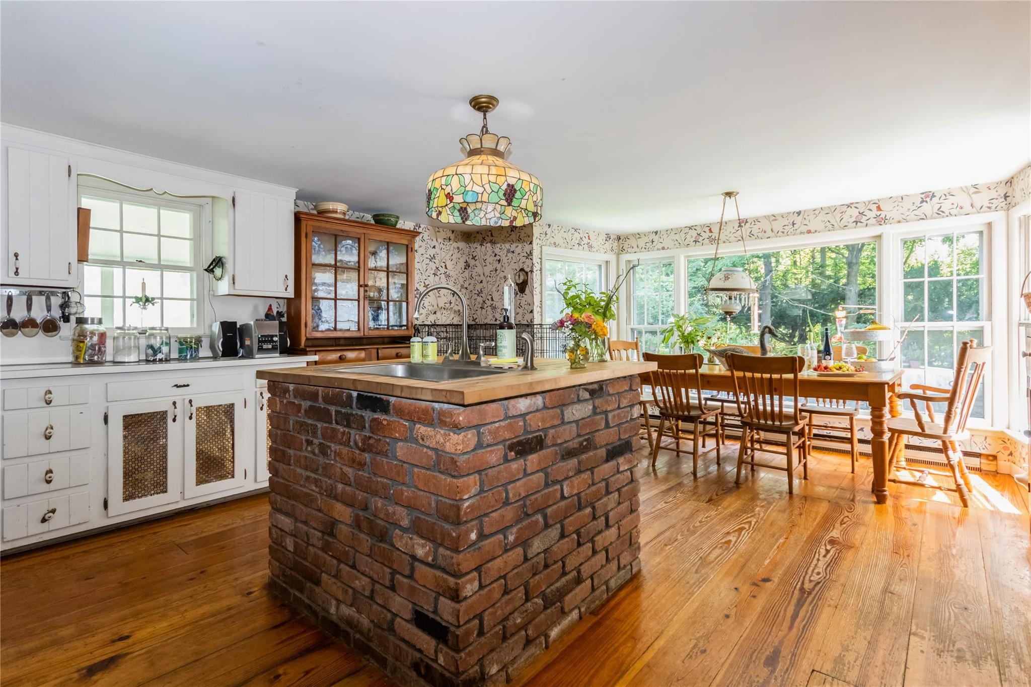 93 Widmer Road Wappingers Falls, NY 12590 - Photo 6 of 45 a living room with kitchen island granite countertop wooden floor and a large window