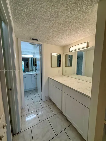 a bathroom with a toilet a sink a mirror and bathtub