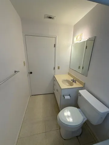 a bathroom with a toilet sink and shower
