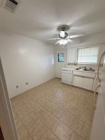 a kitchen with a stove a refrigerator and cabinets