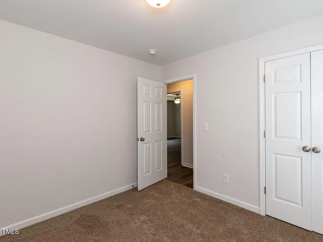 an empty room with closet area