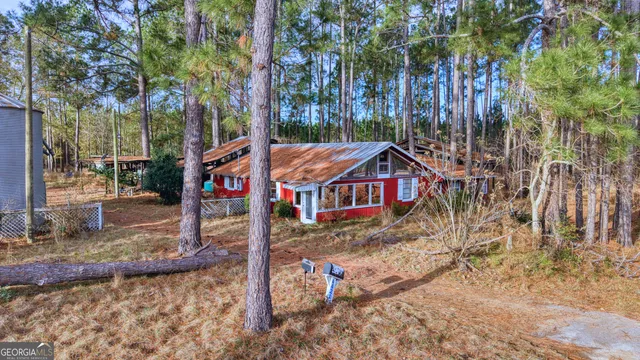 a aerial view of a house with a yard table and chairs