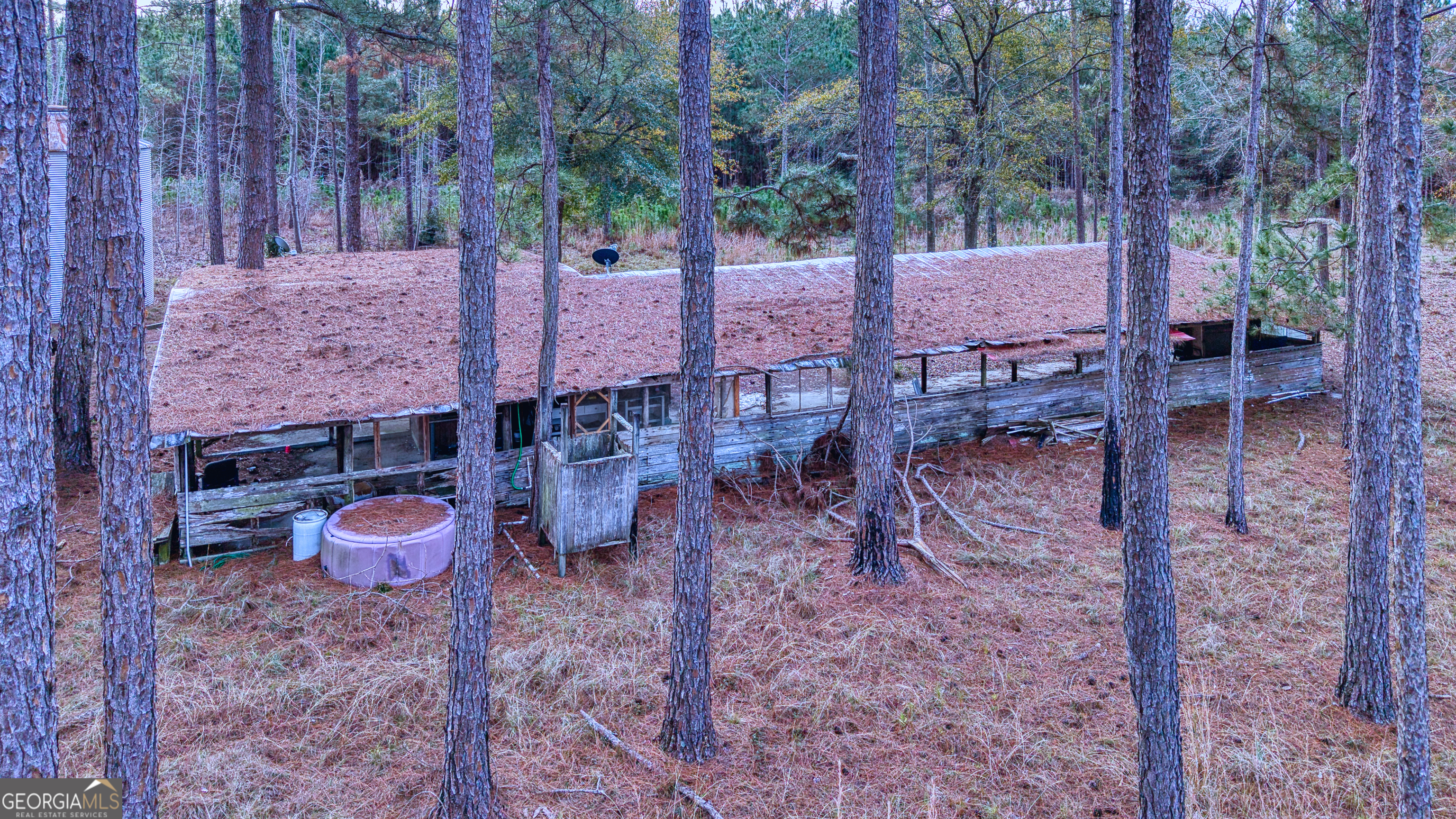 4421 Albert Rahn Road Glennville, GA 30427 - Photo 13 of 73 a backyard of a house with barbeque oven table and chairs