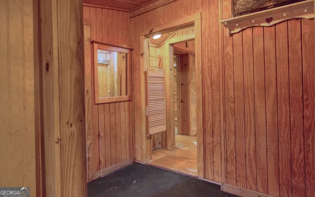a view of a hallway with entryway wooden floor and front door