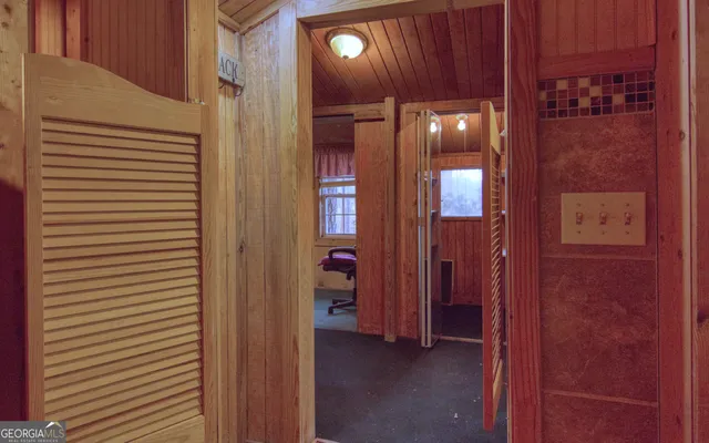 a view of a barn with wooden fence