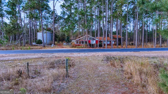 a view of a house with yard and sitting area