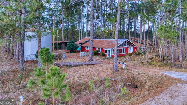 a aerial view of a house with a yard table and chairs