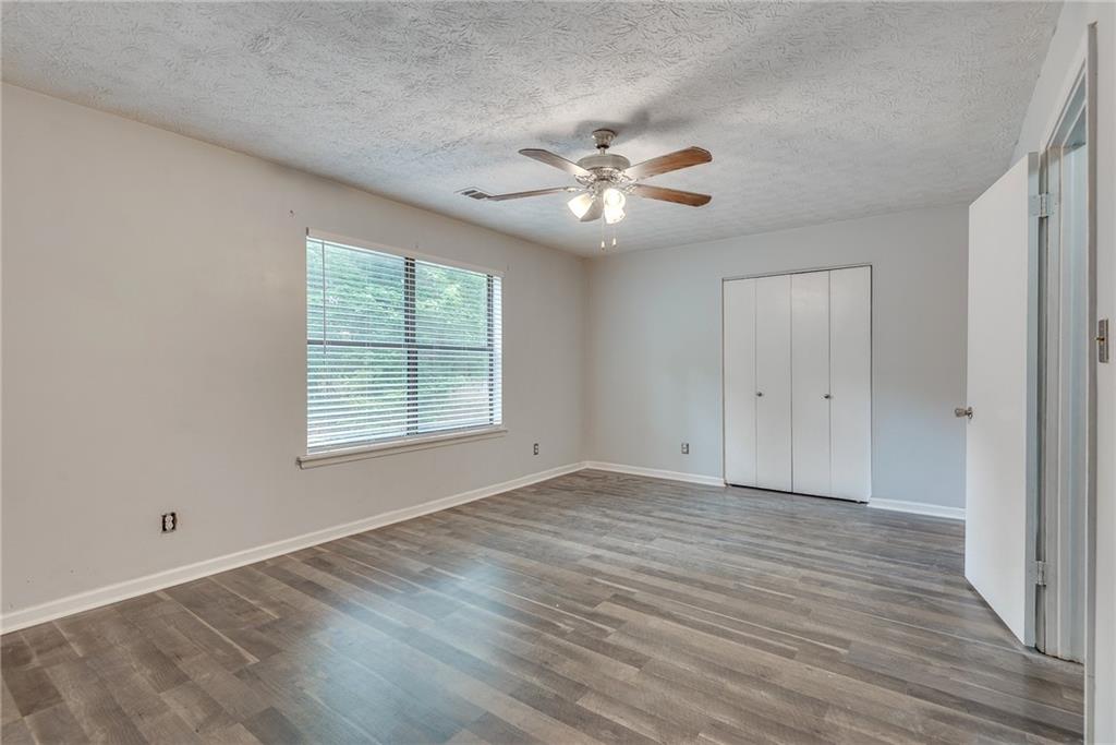 5611 Whittondale Road Lithonia, GA 30058 - Photo 18 of 34 a view of empty room with wooden floor and fan