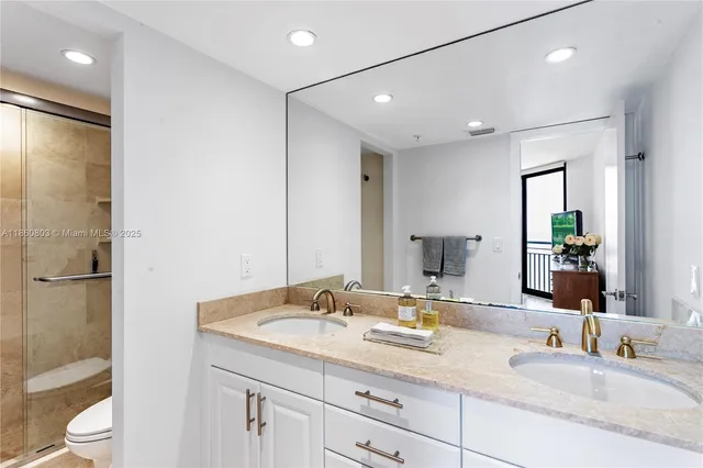 a bathroom with a granite countertop sink mirror and double