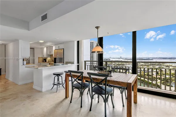a view of a dining room with furniture and window