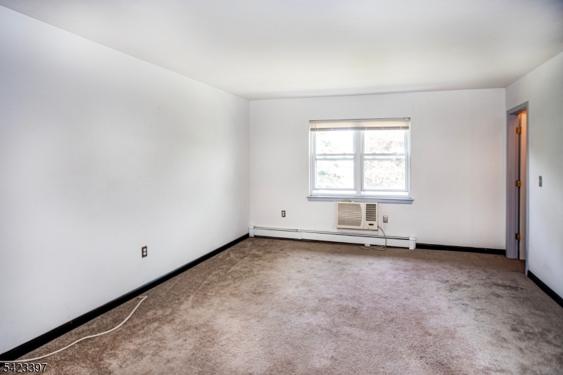 1130 Valley Road, Unit 2B Wayne, NJ 07470 - Photo 5 of 47 an empty room with a window